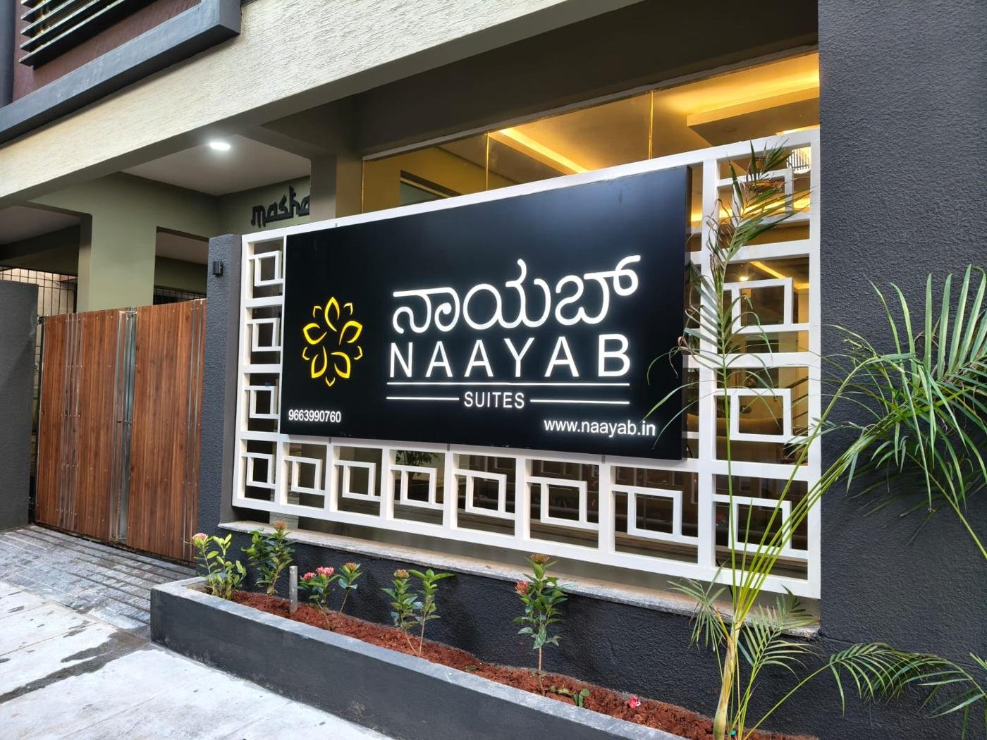 Naayab Suites illuminated signboard at the entrance